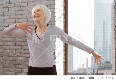 Positive aging woman mastering dance skills at the 29626895