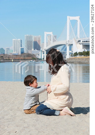 A child hitting the stomach of a pregnant mother A child hitting the stomach of a pregnant mother 29627104
