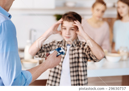 Father punishing his son for smooking Father punishing his son for smooking 29630737