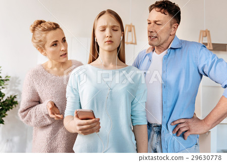 Caring parents scoldign their daughter 29630778