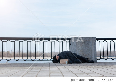 Elderly man having rest on the pavement Elderly man having rest on the pavement 29632432