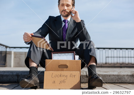 Upset jobless male holding his reward 29632797