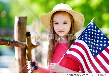 Adorable little girl holding american flag outdoors on beautiful summer day 29634824