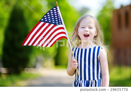 Adorable little girl holding american flag outdoors on beautiful summer day 29635778