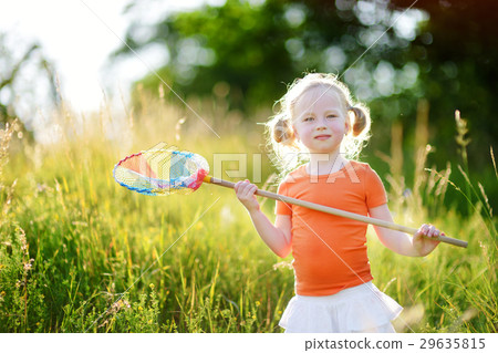 Cute little girl catching butterflies and bugs with her scoop-net 29635815