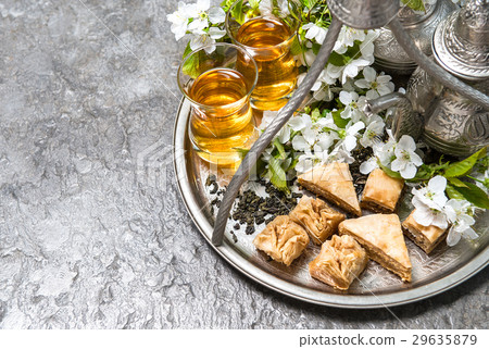 Tea glasses and pot, traditional sweets.  29635879