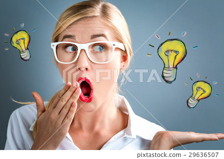 Surprised young business woman with light bulbs 29636507