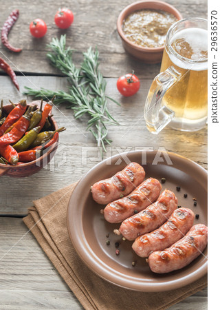 Grilled sausages with mug of beer 29636570
