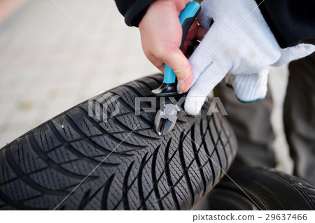 Pulling nail out of tire 29637466