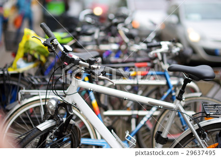 Colorful bikes parked by a sidewalk Colorful bikes parked by a sidewalk 29637495