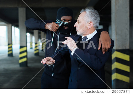 Scared worried businessman being threatened Scared worried businessman being threatened 29637874