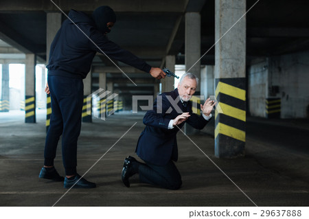 Serious scared businessman standing on his knees Serious scared businessman standing on his knees 29637888