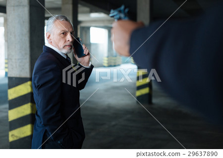 Unhappy worried man looking at the handgun 29637890