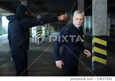 Handsome anxious businessman being in danger Handsome anxious businessman being in danger 29637892