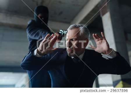 Unhappy frightened man being abducted 29637896