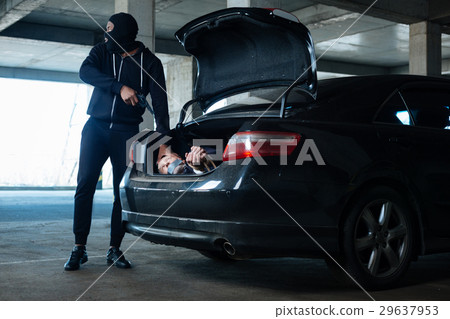 Worried dangerous criminal putting his victim in 29637953