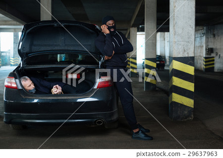 Dangerous aggressive criminal guarding a hostage 29637963