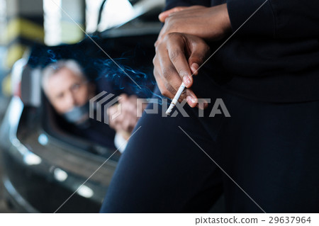 Selective focus of a cigarette being smoked 29637964