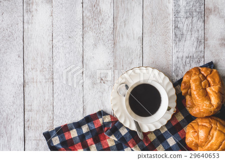 Coffee cup with bread on wooden table 29640653
