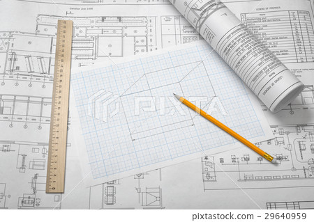 A set of open and rolled up blueprints on wooden 29640959