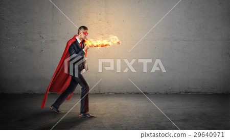 A businessman in a red superhero cape and a 29640971