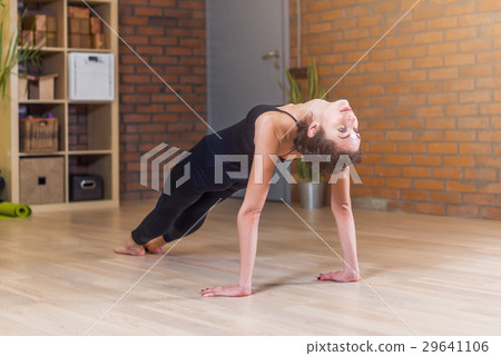 Woman doing yoga exercise standing in Table Top 29641106