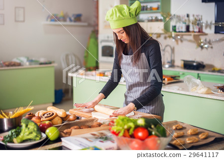 Young woman in casual clothes, apron and hat Young woman in casual clothes, apron and hat 29641117