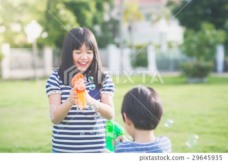 Asian chid Shooting Bubbles from Bubble Gun Asian chid Shooting Bubbles from Bubble Gun 29645935