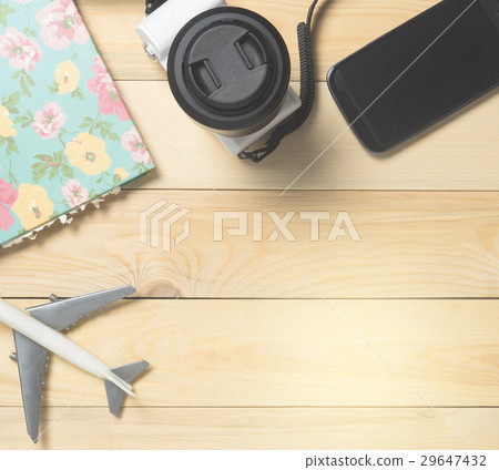 Air travel accessories flat lay on wood with copy  29647432