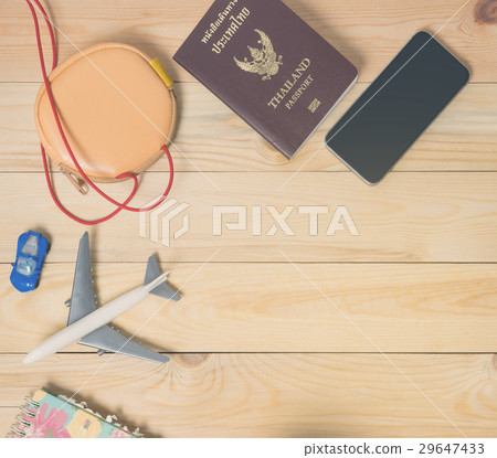 Air travel accessories flat lay on wood with copy  29647433