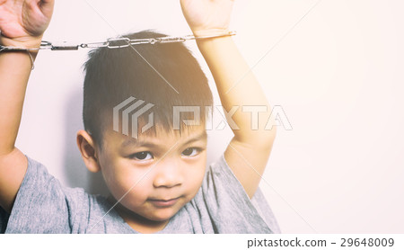 Naughty Asian kid with his hand cuffed. Naughty Asian kid with his hand cuffed. 29648009