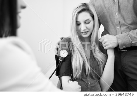 Doctor measuring blood pressure of her pregnant Doctor measuring blood pressure of her pregnant 29648749
