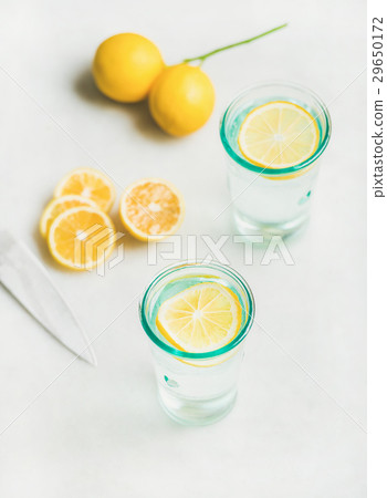 Detox lemon water in glasses served with fresh Detox lemon water in glasses served with fresh 29650172