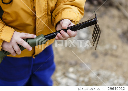 young boy play with rake 29650912