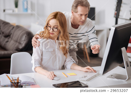 Flirting boss hugging young secretary in the 29653207