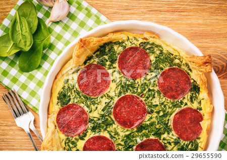 Tart with spinach and slices of salami. Tart with spinach and slices of salami. 29655590