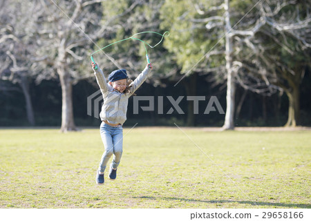 Girls practicing jump rope 29658166