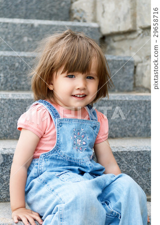 Baby girl sitting on the stone stairs 29658716
