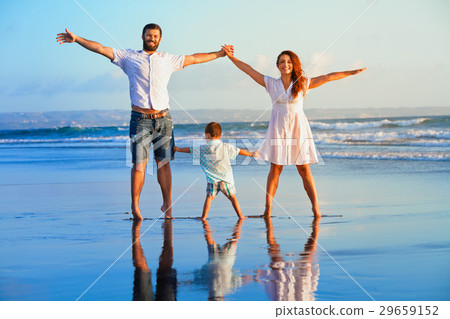 Happy family - father, mother, baby on beach Happy family - father, mother, baby on beach 29659152