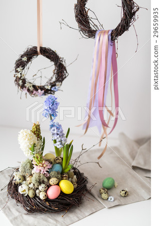 Flower arrangement in a nest with easter eggs  29659935