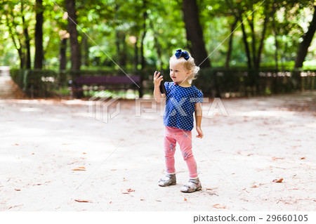 Little girl is looking into the phone 29660105
