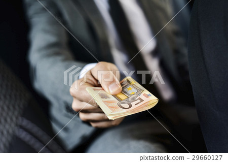 man with a wad of euro bills man with a wad of euro bills 29660127