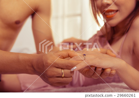 Men are wearing a ring to a beautiful woman 29660261