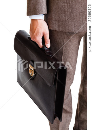 A man in a classic suit holds a brown briefcase 29660306