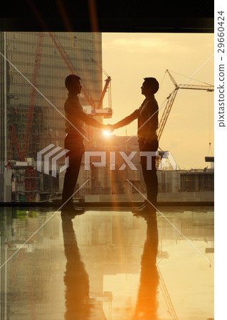 Businessman handshake behind the building 29660424