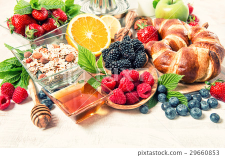Breakfast with croissants, muesli, fresh berries.  29660853