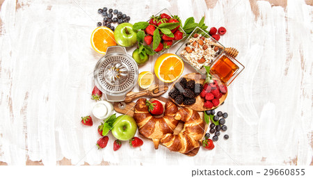 Breakfast with croissants muesli fresh berries Breakfast with croissants muesli fresh berries 29660855