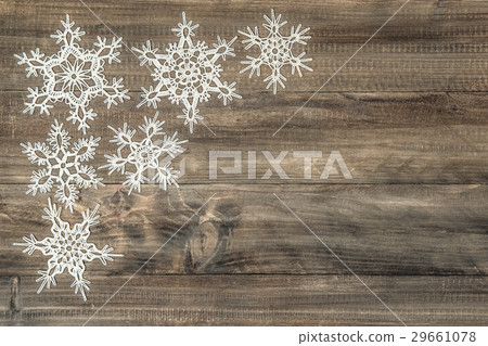 Snowflakes over rustic wooden background. Snowflakes over rustic wooden background. 29661078