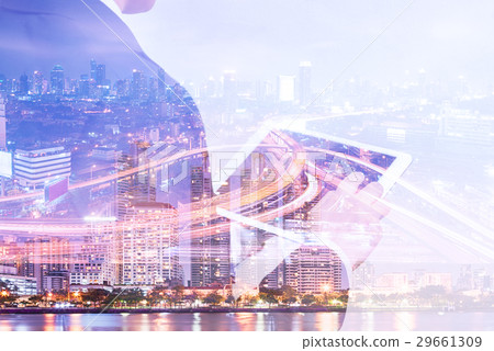 Double exposure businessman using tablet  29661309