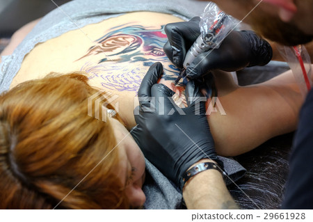 Artist is making the tattoo close up 29661928